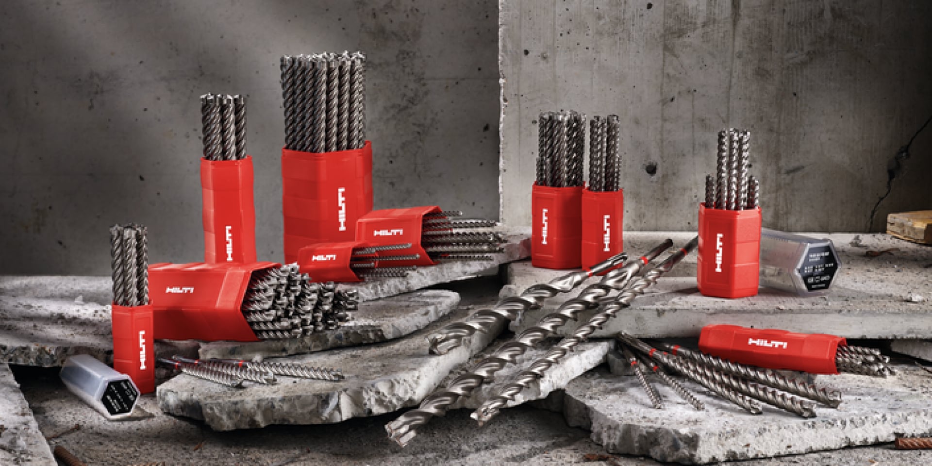 A collection of TE CX drill bits placed atop a mound of rubble